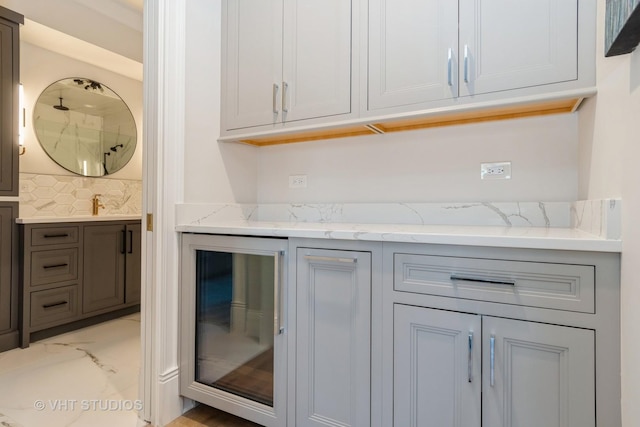 kitchen with light stone countertops and backsplash