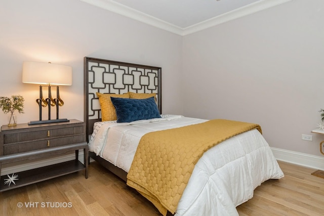 bedroom featuring hardwood / wood-style flooring and ornamental molding