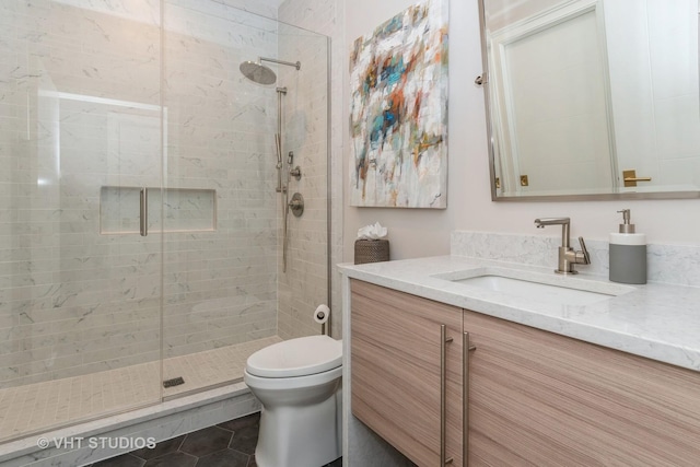 bathroom featuring toilet, tile patterned flooring, walk in shower, and vanity