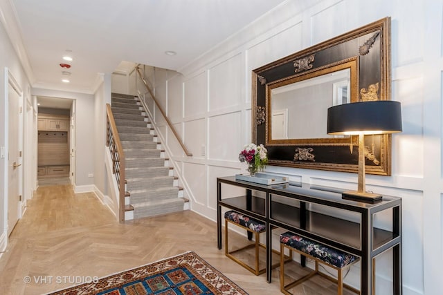 interior space with crown molding and parquet floors