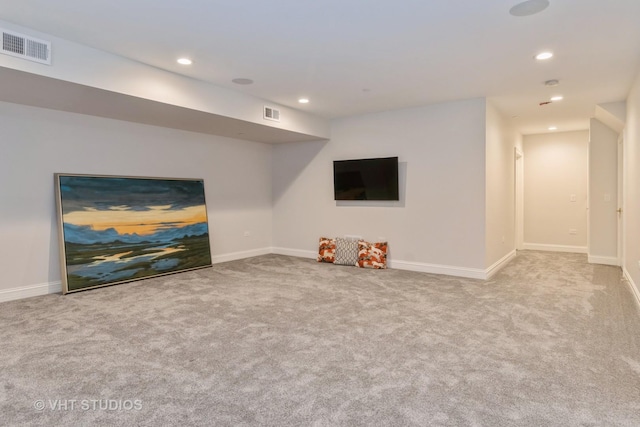 unfurnished living room with light colored carpet