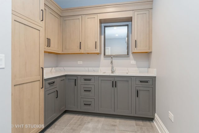 kitchen with gray cabinetry and sink