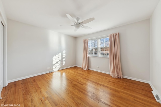 empty room featuring ceiling fan and light hardwood / wood-style flooring