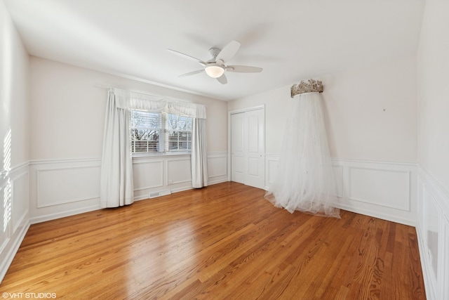 spare room with ceiling fan and light hardwood / wood-style floors