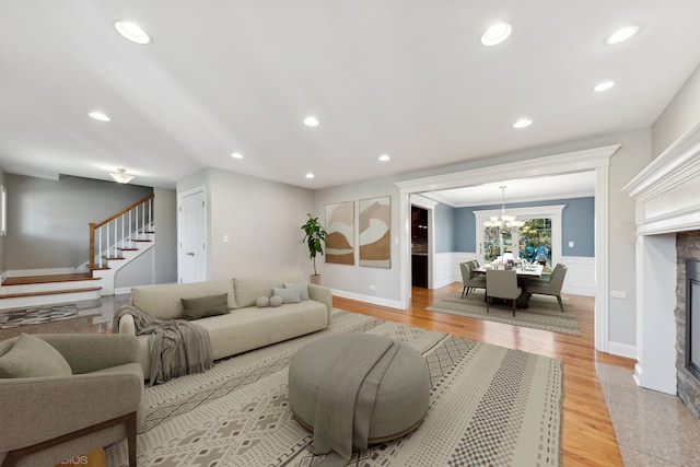 living room with a notable chandelier and light hardwood / wood-style floors