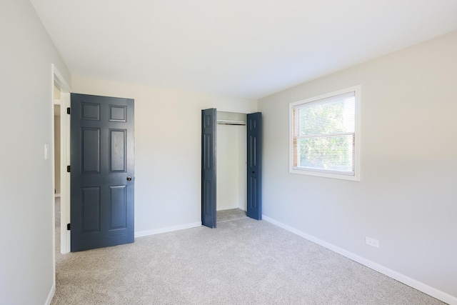 unfurnished bedroom featuring light carpet