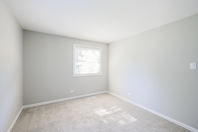 spare room with light carpet