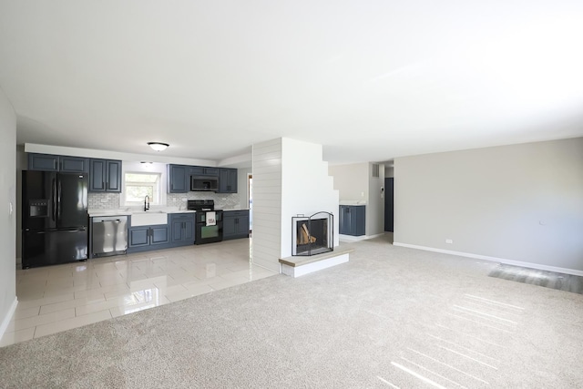 unfurnished living room with light tile patterned floors and sink