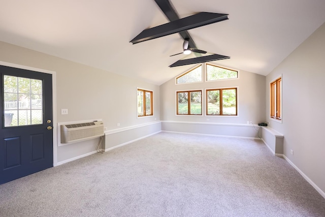 carpeted spare room with ceiling fan, lofted ceiling with beams, and a wall mounted air conditioner