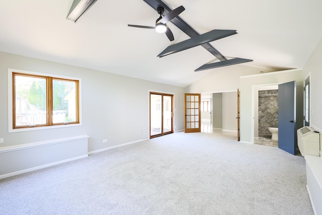 unfurnished room featuring light carpet, french doors, a wall mounted AC, ceiling fan, and lofted ceiling with beams