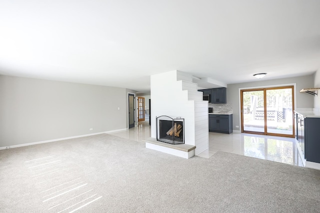 unfurnished living room featuring light colored carpet