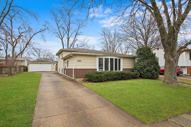 view of front of home with an outbuilding, a garage, and a front lawn