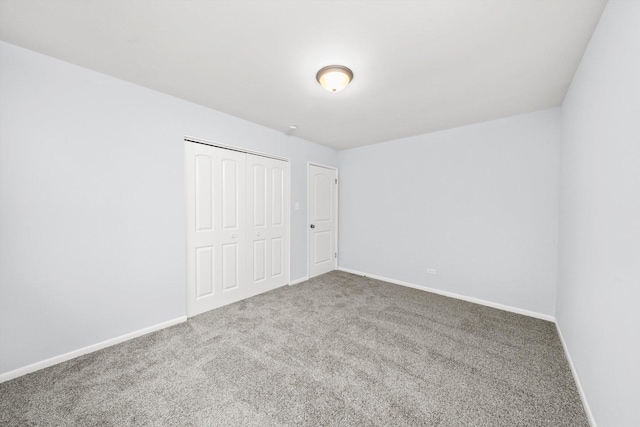 unfurnished bedroom featuring carpet and a closet