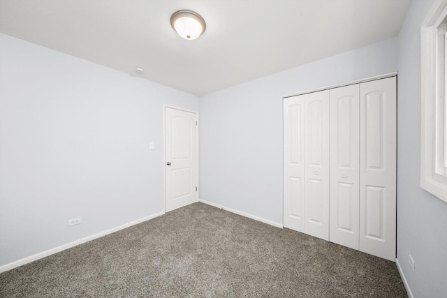 unfurnished bedroom featuring carpet floors and a closet