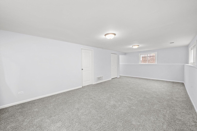 basement with a wealth of natural light and carpet