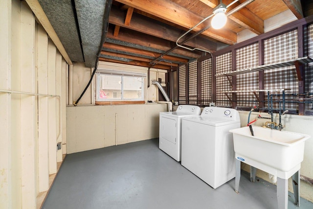 washroom featuring washing machine and dryer and sink