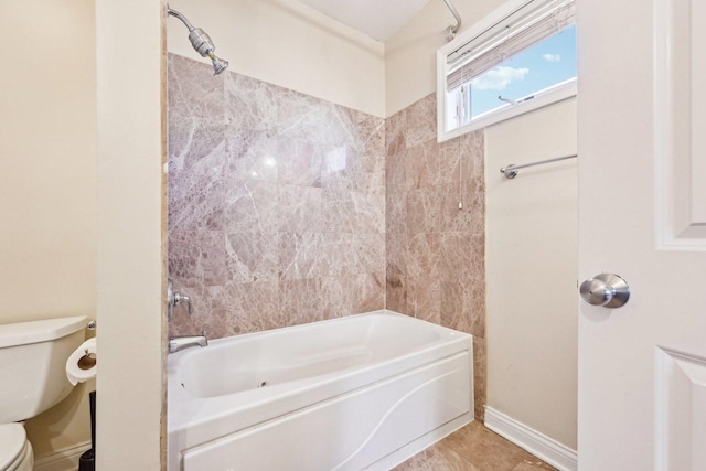 bathroom with shower / bathing tub combination, tile patterned flooring, toilet, and baseboards