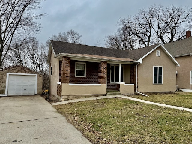 single story home with a front lawn, covered porch, an outdoor structure, and a garage