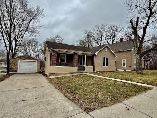 single story home featuring an outbuilding, a garage, covered porch, and a front yard