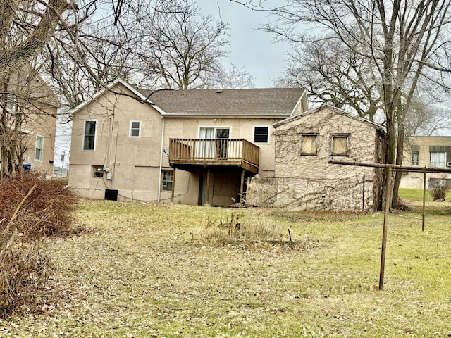 rear view of property with a deck and a lawn