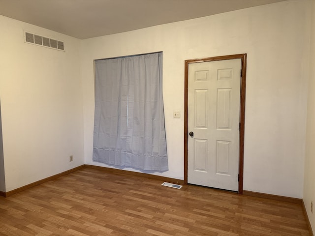 unfurnished bedroom featuring light wood-type flooring