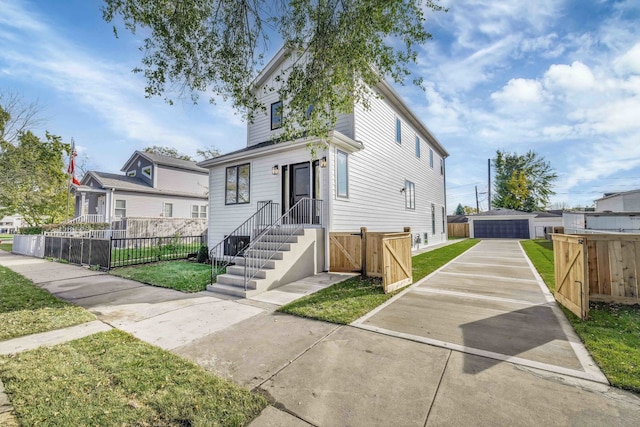 view of front of property with a front yard, fence, and an outbuilding