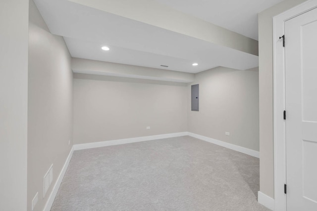 finished basement with light carpet, electric panel, visible vents, baseboards, and recessed lighting