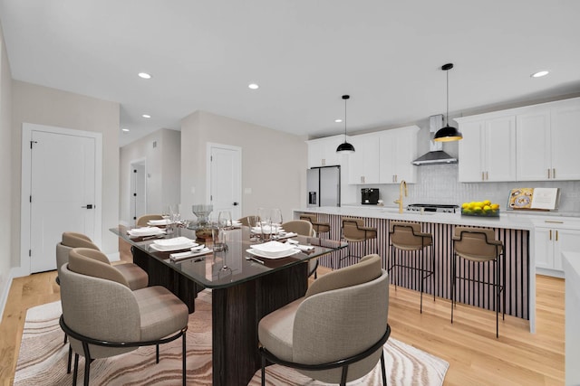 dining area with recessed lighting and light wood-style floors