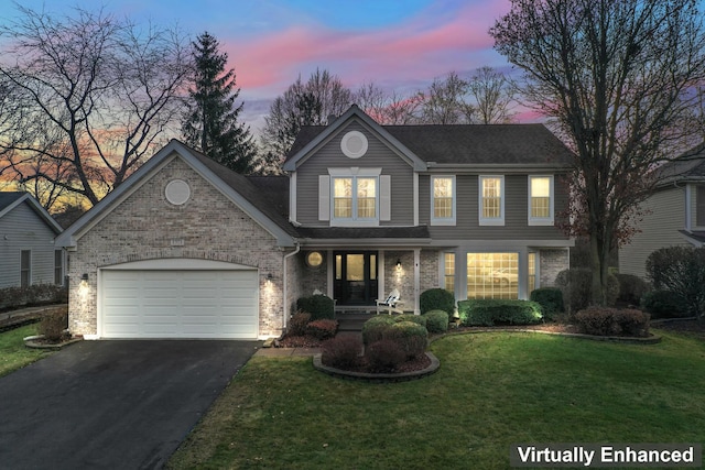 front facade with a yard and a garage