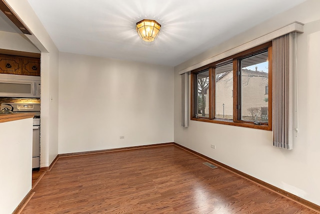 spare room featuring dark hardwood / wood-style flooring