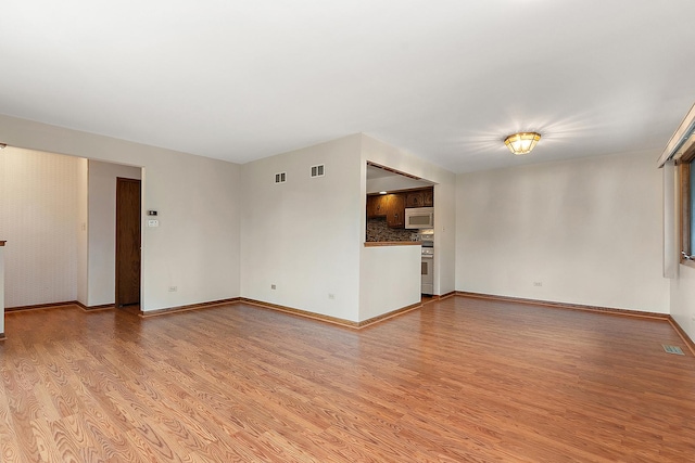 unfurnished living room with light wood-type flooring