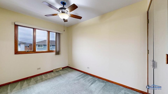 unfurnished room with ceiling fan and carpet floors