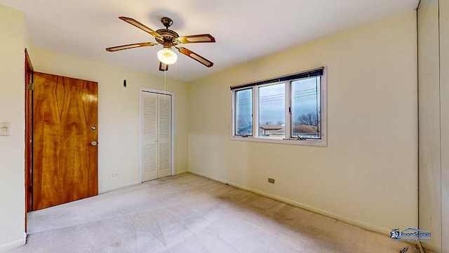 unfurnished bedroom with light colored carpet and ceiling fan