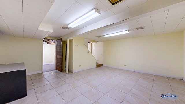 basement with light tile patterned flooring