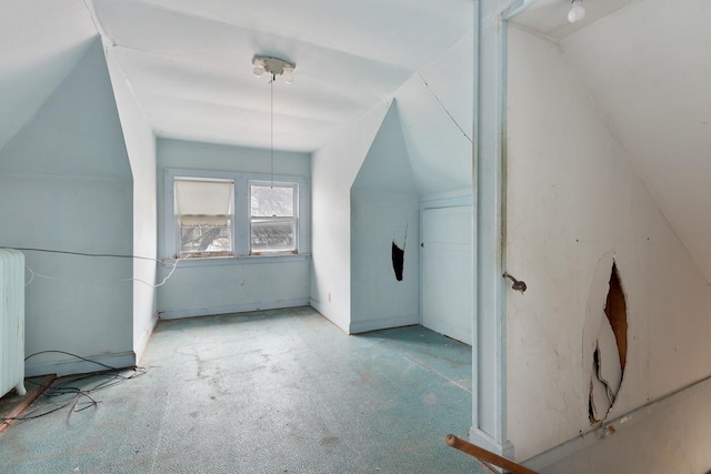 bonus room featuring light colored carpet and vaulted ceiling