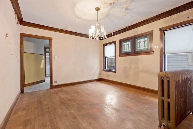 unfurnished room featuring crown molding, light hardwood / wood-style flooring, radiator, and an inviting chandelier