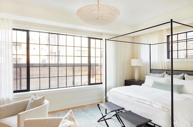 bedroom featuring hardwood / wood-style flooring and a chandelier