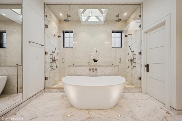 bathroom featuring a healthy amount of sunlight, shower with separate bathtub, and tile walls