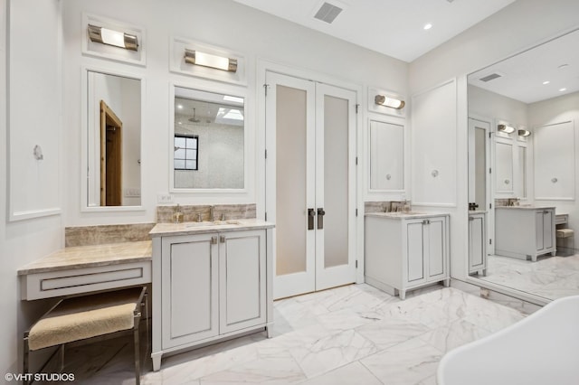 bathroom featuring vanity and a washtub