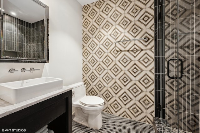 bathroom featuring tile patterned floors, vanity, toilet, and a shower with door