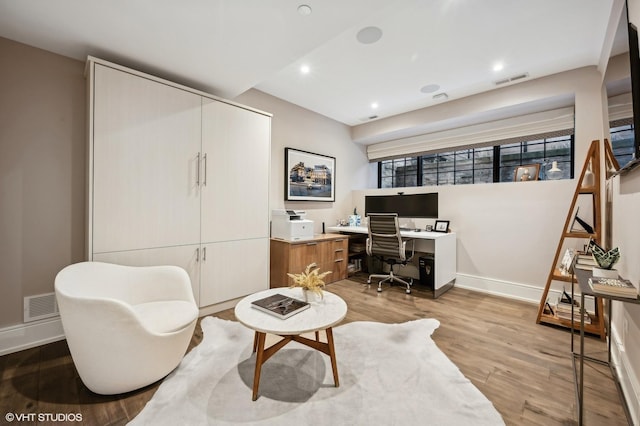 office area with light hardwood / wood-style floors