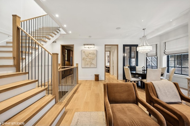 living room featuring an inviting chandelier and light hardwood / wood-style floors