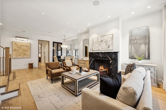 living room with a fireplace and light hardwood / wood-style floors