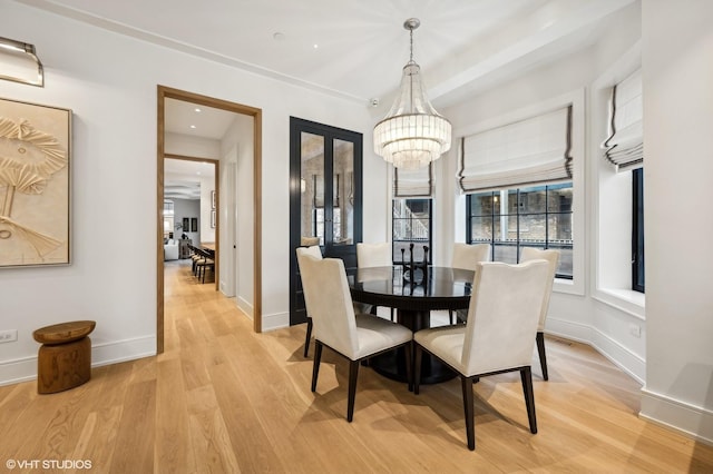 dining area featuring a chandelier and light hardwood / wood-style flooring