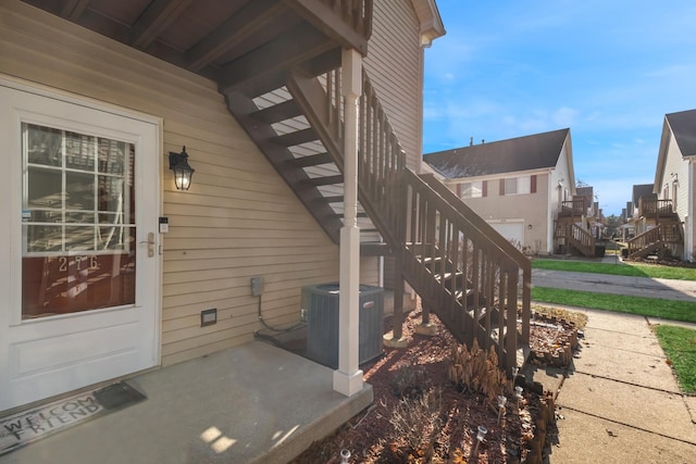 doorway to property featuring central air condition unit