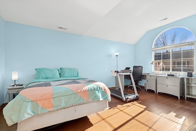 bedroom featuring dark wood-type flooring and vaulted ceiling