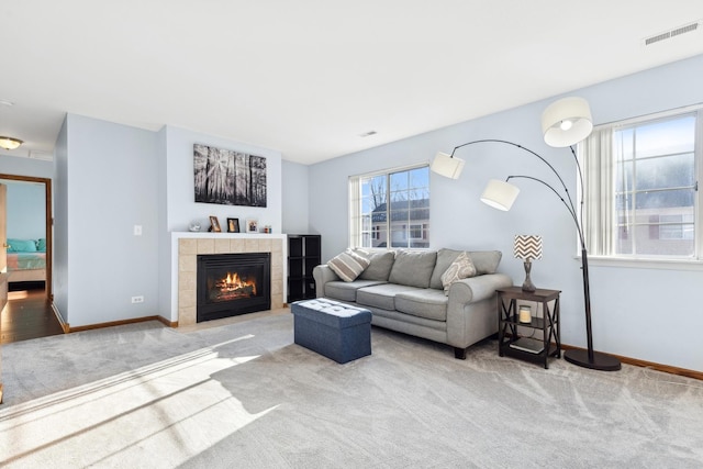 carpeted living room featuring a fireplace