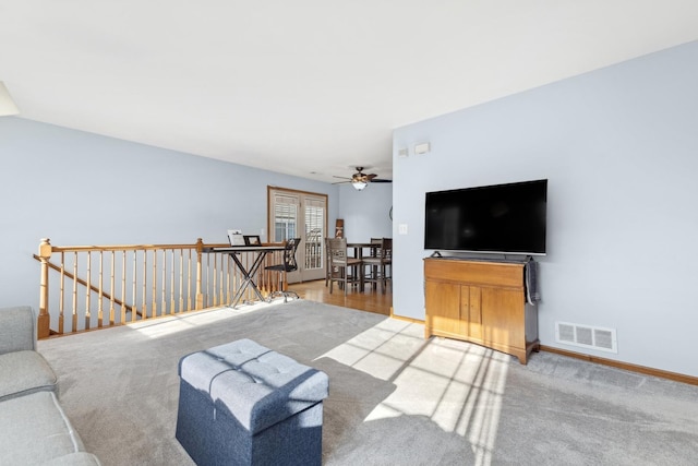 living room featuring carpet flooring and ceiling fan