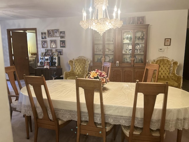 dining space with ceiling fan with notable chandelier