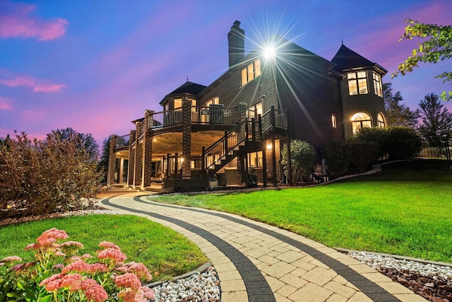 back house at dusk with a yard